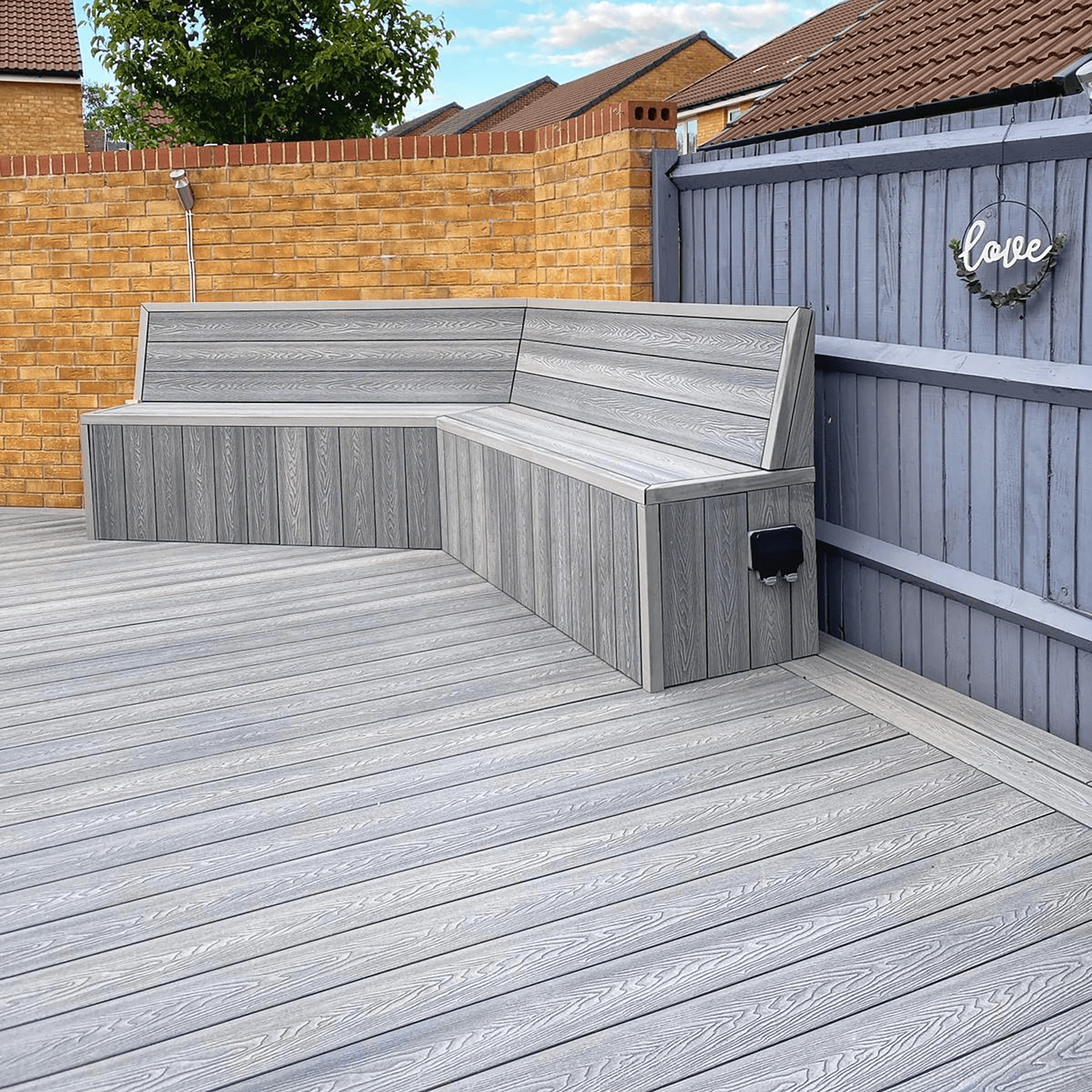composite decking seating area with decking in a light grey stone colour