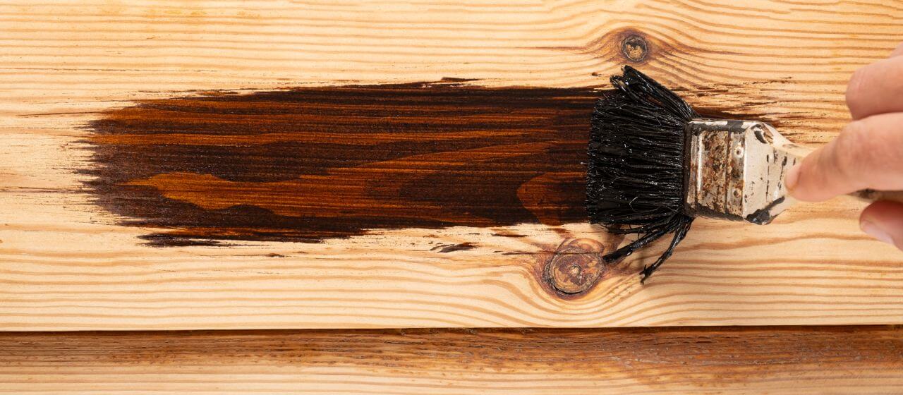 close up shot of a wooden deck being stained