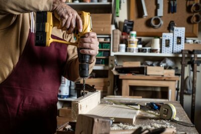 man working on a project using a drill