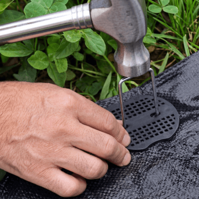 garden weed matt ground peg installation